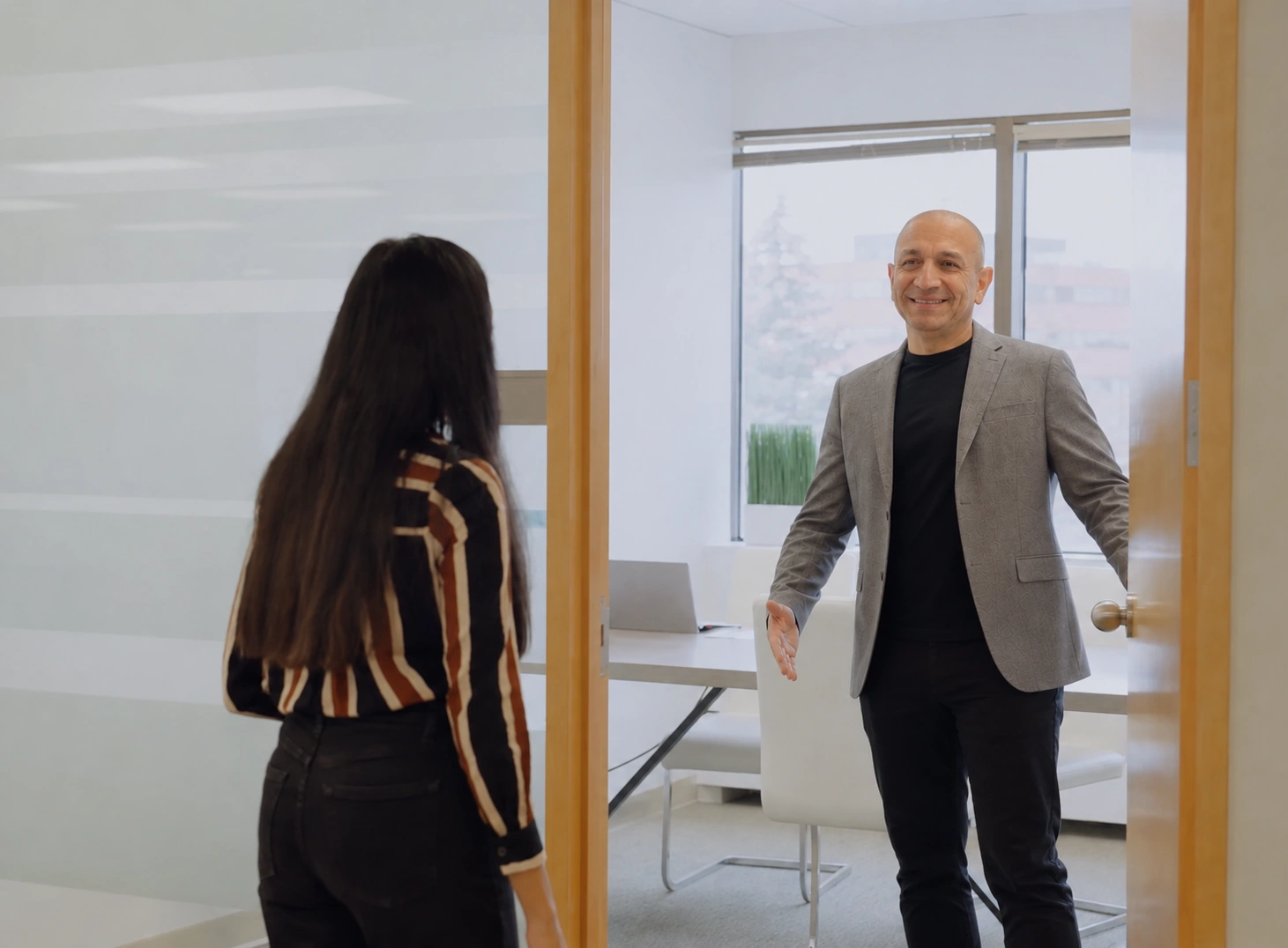 Carlos Castillo welcoming a business client
